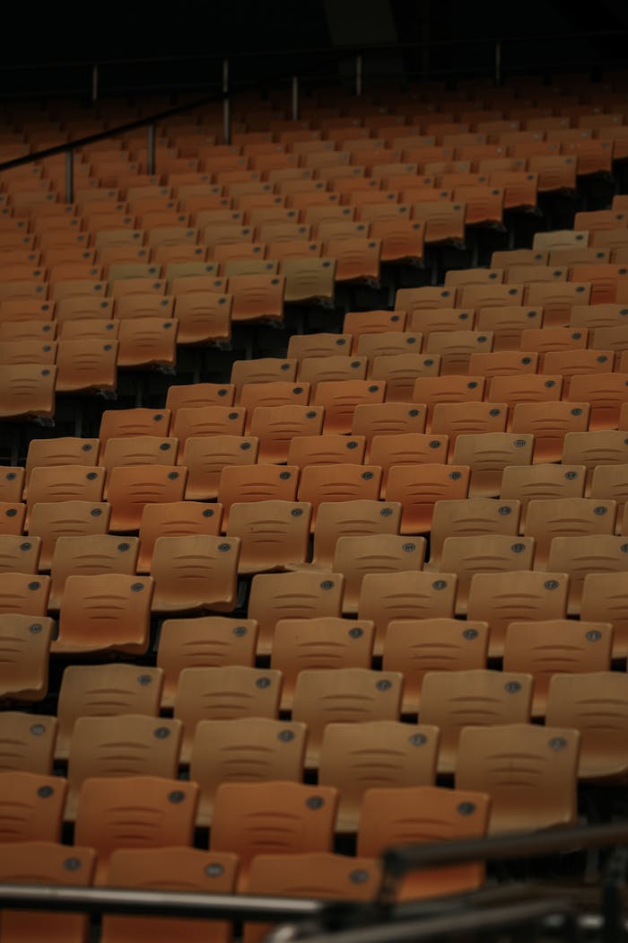Rows of empty seats in a stadium in Guangzhou, China, creating a pattern.