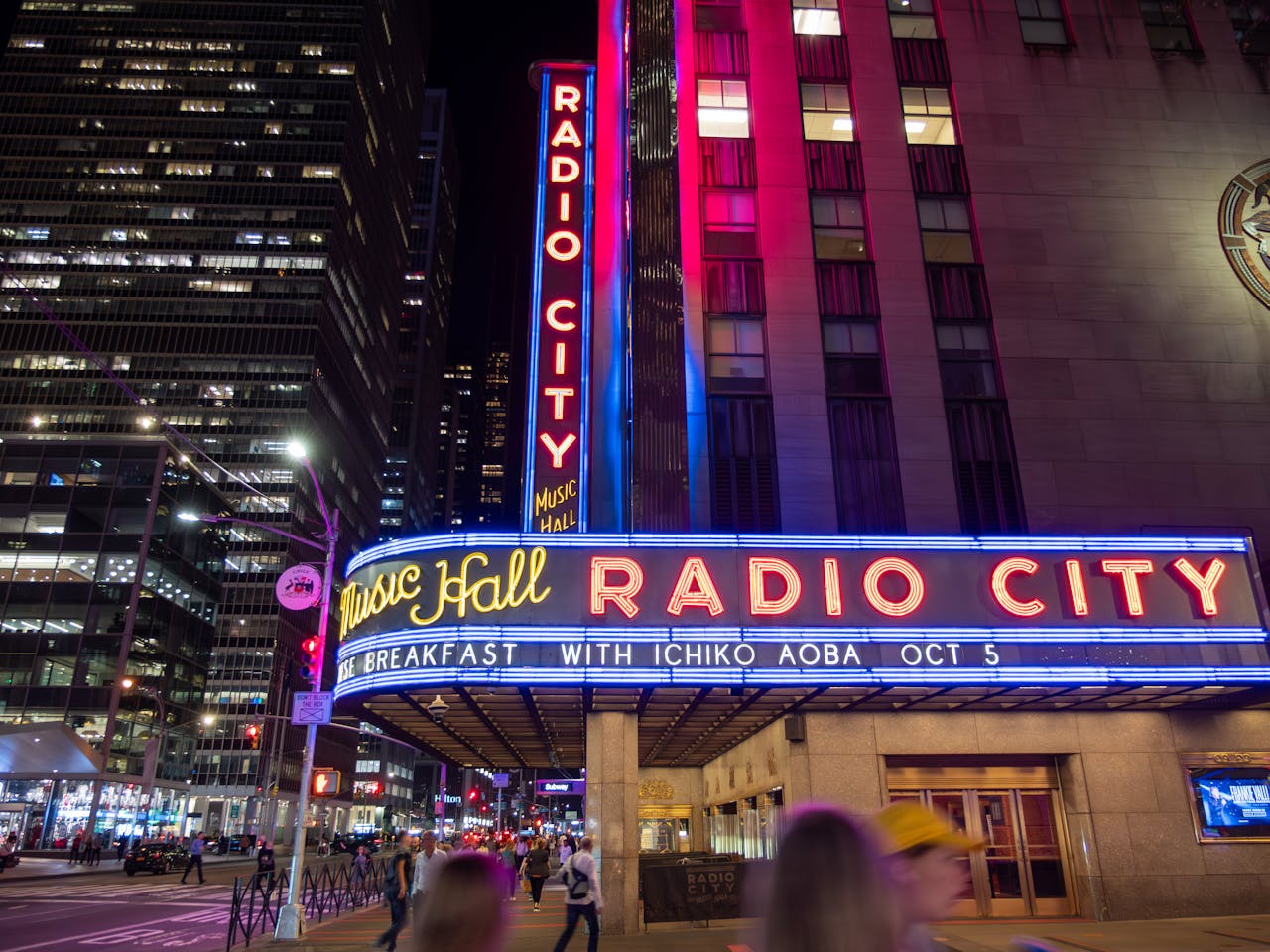 Home Illuminated facade of Radio City Music Hall in New York City at night.
